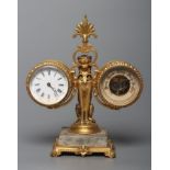 A GILT METAL FIGURAL DESK COMPENDIUM, c.1900, comprising a clock and barometer suspended from a