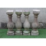 A SET OF FOUR CARVED SANDSTONE BALUSTERS, 19th century, with square capitals and plinths, 8" x