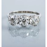 A THREE STONE DIAMOND RING, the brilliant cut stones totalling approximately 2.75cts, claw set to