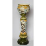 A BURMANTOFTS FAIENCE JARDINIERE AND STAND, early 20th century, moulded and decorated in shades of