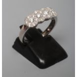A DIAMOND RING, thr four small clusters each point with seven stone to a plain 18ct white gold