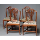 A SET OF FOUR GEORGIAN MAHOGANY DINING CHAIRS, late 18th century, the arched top rail over pierced