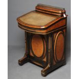 A VICTORIAN YEW AND EBONISED DAVENPORT, the raised stationery compartment with brass gallery on
