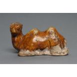 A SMALL TANG STYLE RECUMBENT CAMEL, with museum style/collectors number K61/1706 inscribed in black,