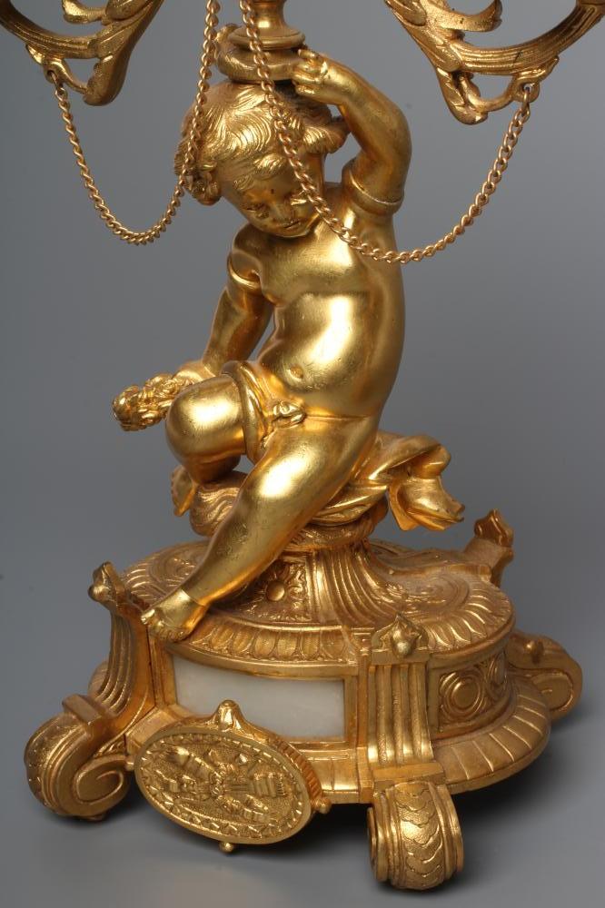 A PAIR OF FRENCH GILT METAL THREE LIGHT FIGURAL CANDELABRA inset with onyx panels, early 20th - Image 3 of 4