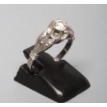 A SOLITAIRE DIAMOND RING, the brilliant cut stone of approximately 0.5cts claw set to a flower panel