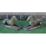 A PAIR OF CAST STONE RECUMBENT GREYHOUNDS on canted oblong bases, 27" x 10 1/2" x 16" (Est. plus 24%