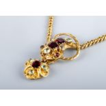 A VICTORIAN GOLD SNAKE NECKLACE, the head with cabochon garnet eyes, two square cut garnets and four