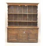 AN OAK DRESSER, 17th century and later, the boarded delft rack with moulded cornice and sides and