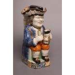 A PRATTWARE TOBY JUG, c.1790, by the "Pottery which uses a Large Crown", the interior of his hat and