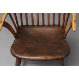 A COMB BACK WINDSOR ARMCHAIR, Welsh 18th century, with curved top rail, shaped tapering arm