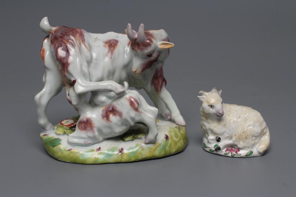 A SMALL BOW PORCELAIN SHEEP, c.1755, modelled recumbent with pale yellow fleece, on a flower painted