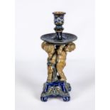 A STONEWARE FIGURAL CANDLESTICK, probably designed by George Tinworth for Doulton Lambeth, the