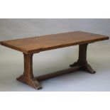 AN OAK REFECTORY TABLE, the three plank 3" thick top on square section end supports with trestle