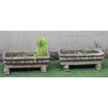 A PAIR OF COMPOSITION STONE JARDINIERES of oblong form with everted rims and cushion moulded