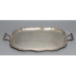 A TWO HANDLED TEA TRAY, maker's mark HA, Sheffield 1920, of shaped oblong form with pie-crust rim,