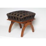 A VICTORIAN WALNUT DRESSING STOOL of square form, the raised upholstered seat in black and gold