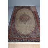 A PERSIAN RUG, the ivory field with all over repeating flowerhead and leaf pattern in shades of