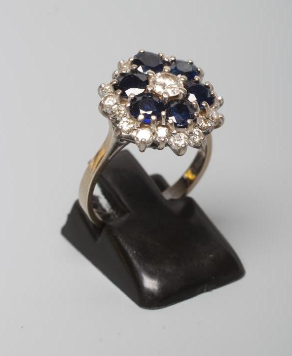 A SAPPHIRE AND DIAMOND CLUSTER RING, the central round brilliant cut diamond in a border of six claw - Image 3 of 3