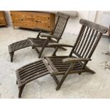 A PAIR OF SLATTED TEAK STEAMER ARMCHAIRS with brass fittings and green weather-proof loose cushions,