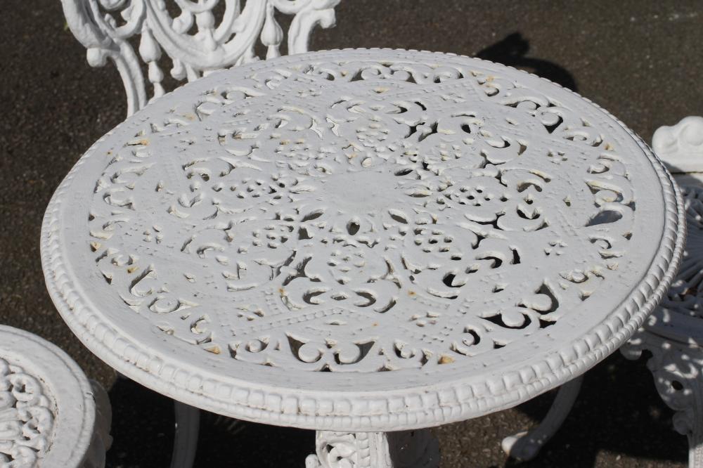 A COALBROOKDALE STYLE HEAVY CAST IRON TERRACE SUITE, comprising a circular table pierced with - Image 4 of 4