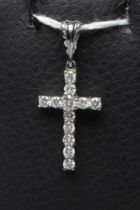 A DIAMOND CROSS PENDANT, the twelve small round brilliants claw set to an 18ct white gold frame with