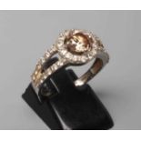 A CHAMPAGNE DIAMOND CLUSTER DRESS RING, the central round brilliant cut stone of approximately 0.