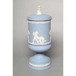 A WEDGWOOD BLUE JASPERWARE PEDESTAL VASE AND COVER, modern, of cylindrical form, moulded and applied