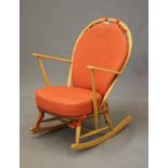 AN ERCOL MODEL 316 ROCKING CHAIR, mid 20th century, in blond beech and elm, with loose cushions in