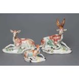 A DERBY PORCELAIN STAG AND HIND, c.1760, each modelled recumbent on a flower encrusted shaped