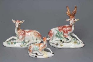 A DERBY PORCELAIN STAG AND HIND, c.1760, each modelled recumbent on a flower encrusted shaped