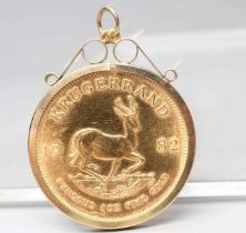 A KRUGERRAND, 1982, in a 9ct gold loose pendant mount, London 1992, 37.2g total (Est. plus 24%