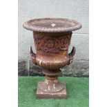 A VICTORIAN CAST IRON URN of half fluted campana form with everted ovolo moulded rim and mask loop