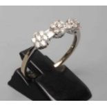 A DIAMOND TRIPLE CLUSTER RING, the seven stone small clusters with two pairs of baguette cut