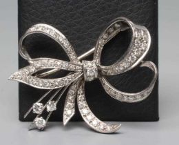 A DIAMOND BOW BROOCH, the white unmarked metal frame pave set with numerous round cut stones (Est.