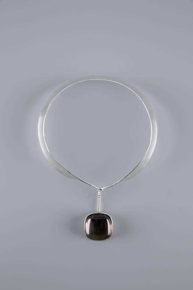 A GEORG JENSEN SILVER NECK RING designed by Vivianna Torun Bulow-Hube, with tension clamp and hung