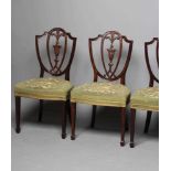 A SET OF SIX MAHOGANY DINING CHAIRS, of Georgian design c.1900, the shield back with carved urn