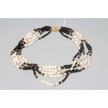 AN ONYX BEAD AND FRESHWATER PEARL FIVE STRAND NECKLACE to a reeded clasp stamped 750, EJ (Est.