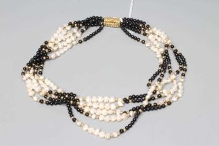 AN ONYX BEAD AND FRESHWATER PEARL FIVE STRAND NECKLACE to a reeded clasp stamped 750, EJ (Est.