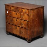 A GEORGIAN WALNUT CHEST, mid 18th century (AF), the associated banded mahogany top over two short