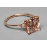 A MORGANITE DRESS RING, the Asscher cut stone claw set and with two small baguette cut stones to