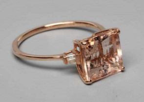 A MORGANITE DRESS RING, the Asscher cut stone claw set and with two small baguette cut stones to