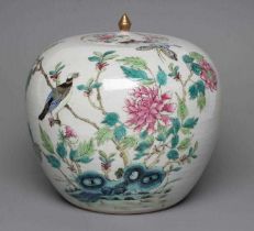 A CHINESE PORCELAIN JAR AND COVER of rounded cylindrical form, painted in colours with an exotic