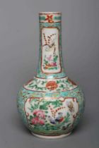 A CHINESE PORCELAIN BOTTLE VASE painted in colours with panels of flowers, birds and butterflies