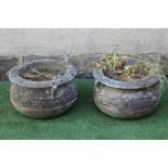 A PAIR OF CAST STONE PLANTERS of cauldron form, the moulded rim with three handles over a band of