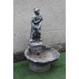A CAST STONE FOUNTAIN modelled as an escallop shell surmounted by a semi clad maiden holding a water