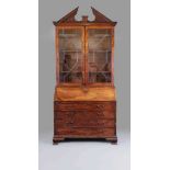 A GEORGIAN MAHOGANY BUREAU BOOKCASE, third quarter 18th century, the moulded cornice with broken