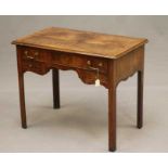 A MAHOGANY LOWBOY, 18th century and later, the moulded edged quarter veneered and banded top over