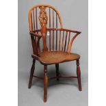 A YEW AND ELM LOW HOOP BACK WINDSOR ARMCHAIR, Thames Valley, 19th century, with wheel splat, crook