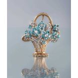 A TOPAZ AND DIAMOND FLOWER BASKET BROOCH, the six claw set blue topaz flower heads all centred by